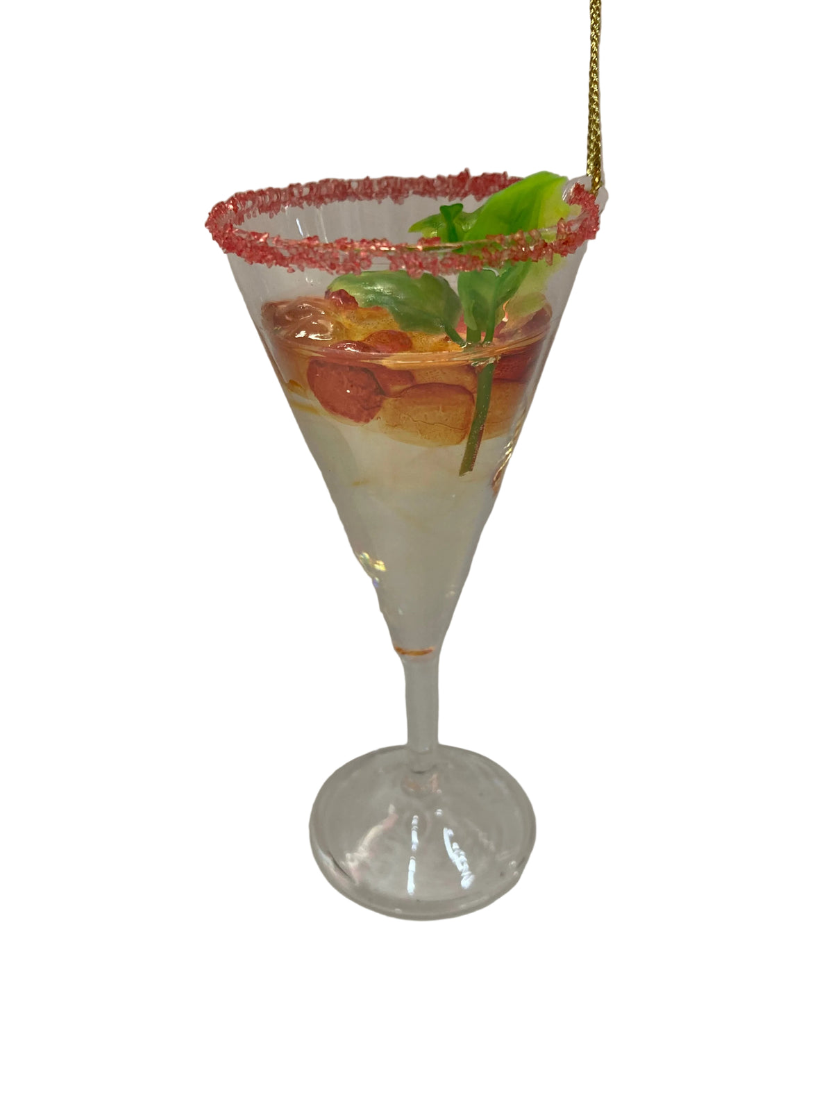 A clear martini-style glass filled with a layered drink, garnished with a pink sugar-rimmed edge, green leaves, and orange slices, photographed on a plain light background.