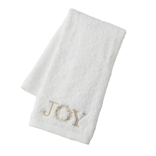 White towel with 'JOY' embroidered in gold on a light gray background