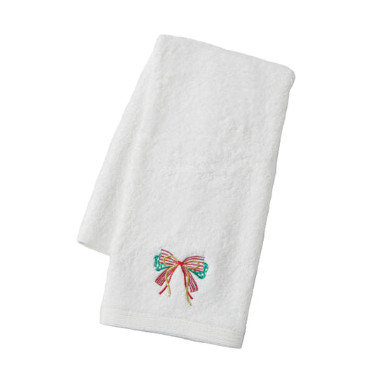 White towel with a colorful embroidered bow on a light gray background