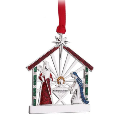 Christmas ornament depicting a nativity scene with a stable, baby Jesus, Mary, and Joseph on a white background.