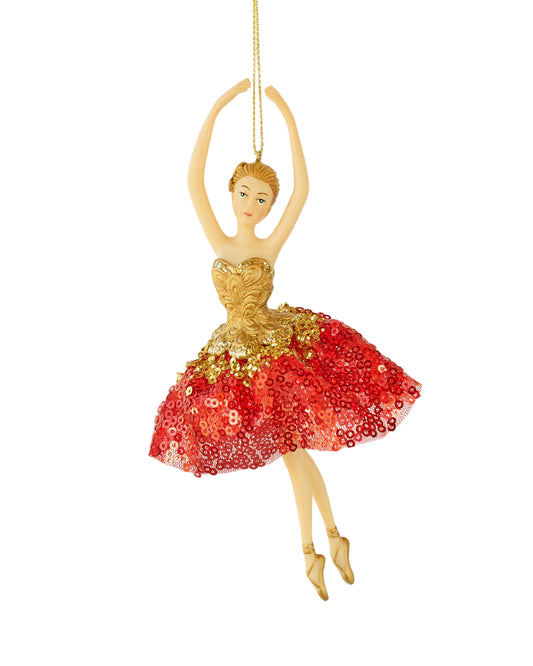 Decorative ballerina ornament with gold and red dress on a white background