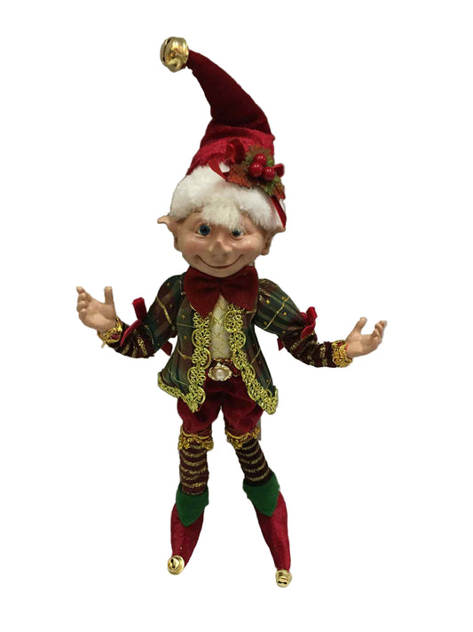 Elf doll in festive outfit with red hat and green pants on a white background