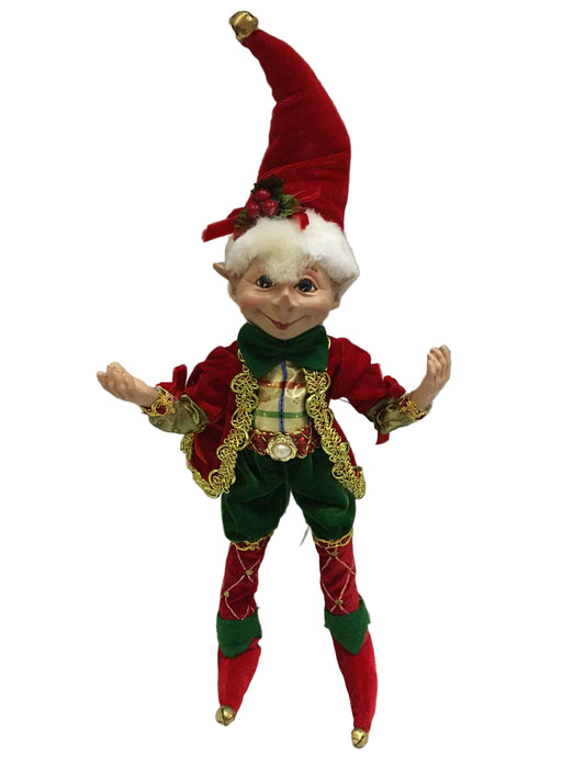 Elf figurine with red and green outfit on a white background